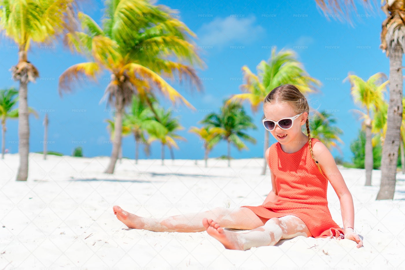 Little Girl Sitting At The Beach: Stock Photos
