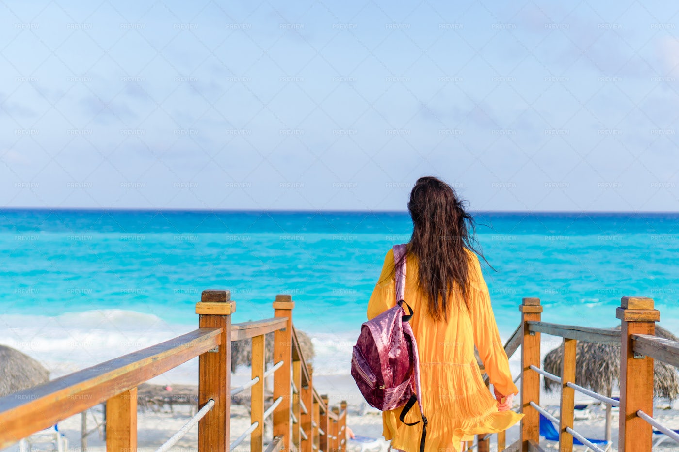 Woman Walking Towards The Coast: Stock Photos