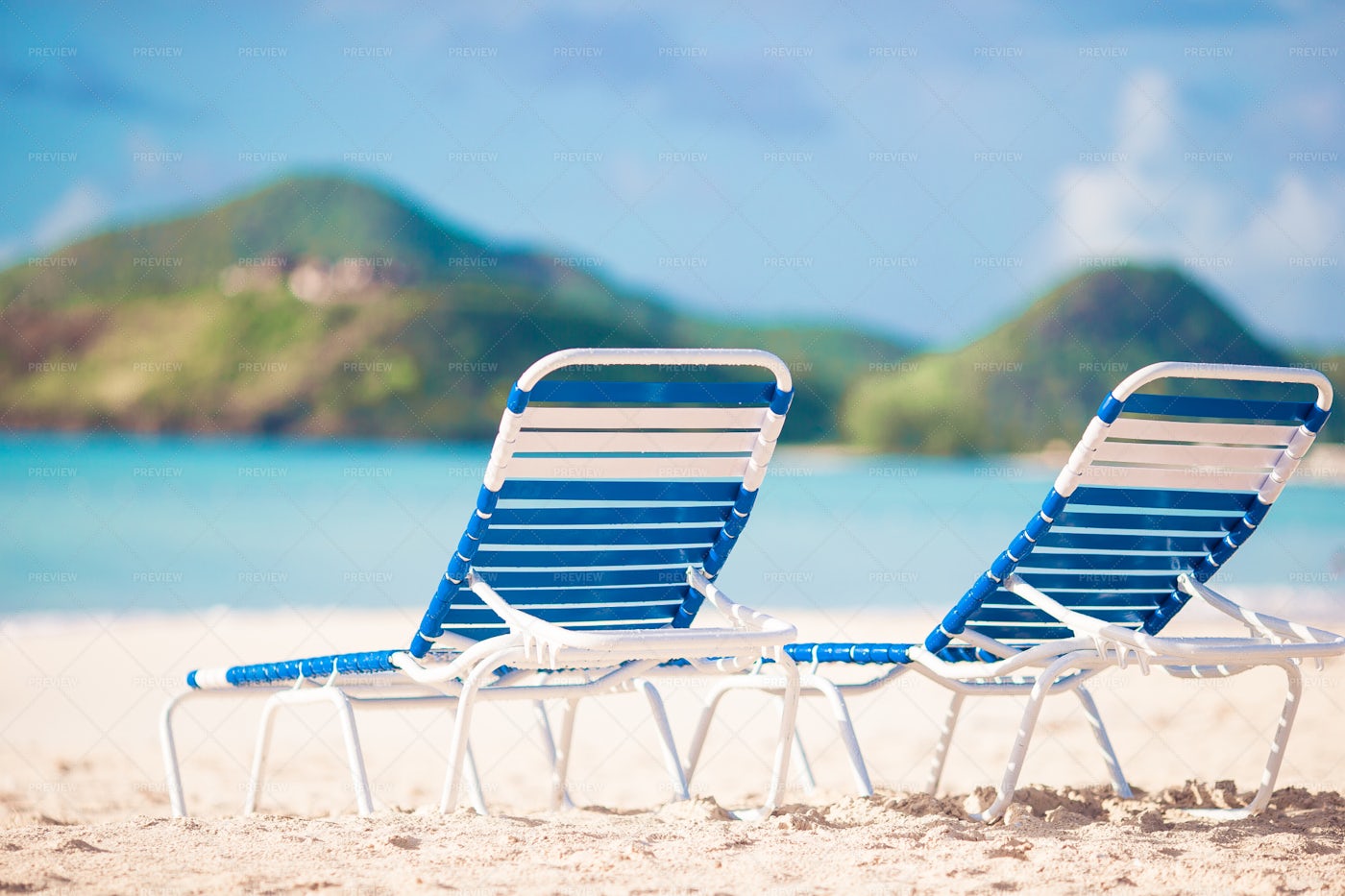 White Lounge Chairs On The Beach: Stock Photos