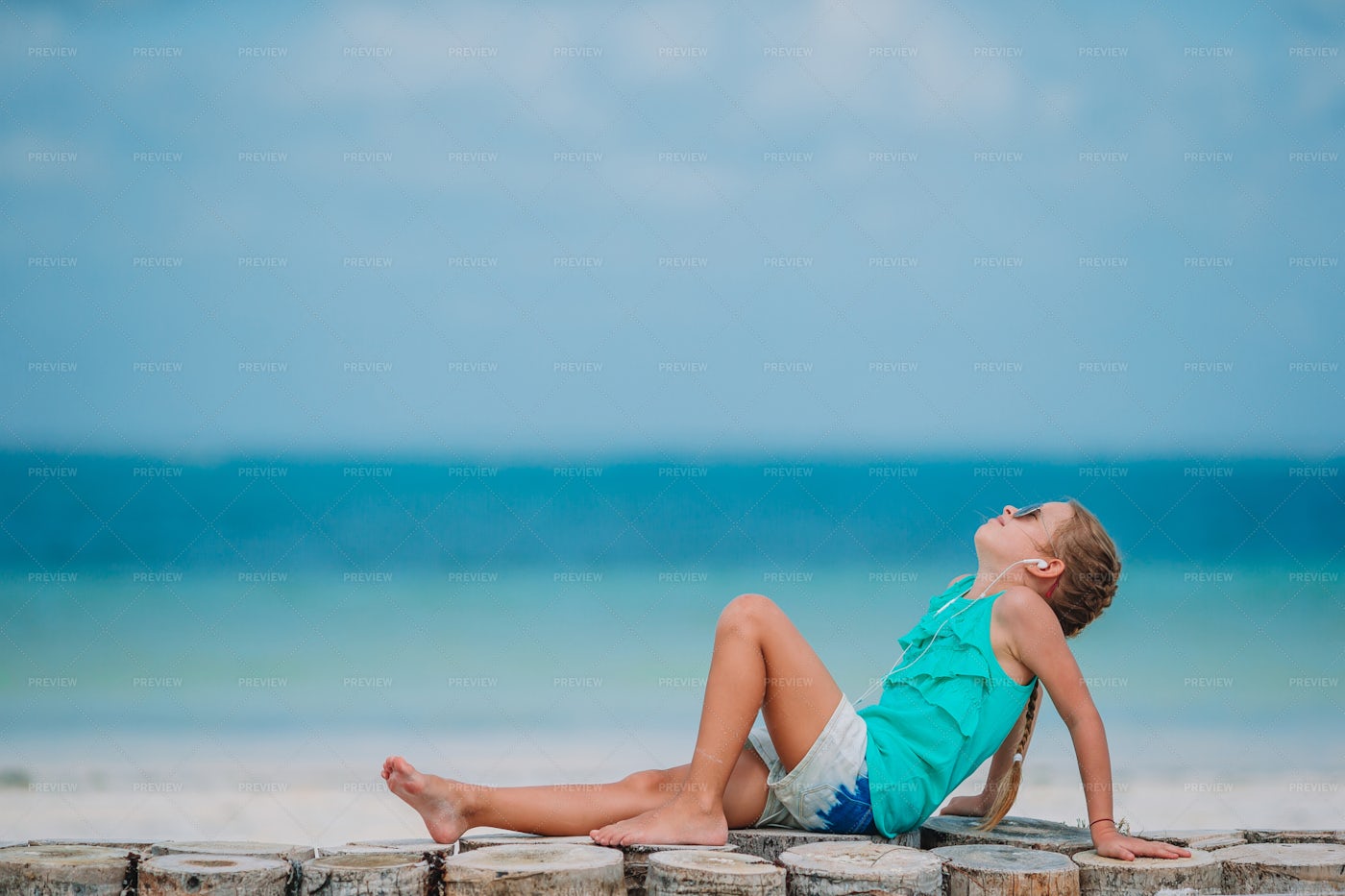 Girl Listening To Music On The Beach: Stock Photos