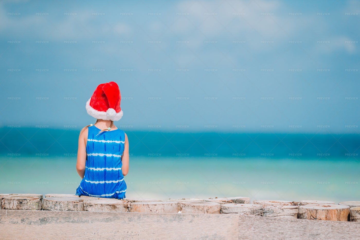 Girl At The Beach In Santa's Hat: Stock Photos