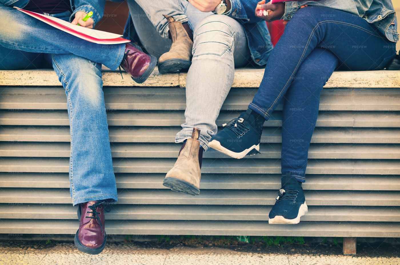 Legs Of People Sitting On A Bench.: Stock Photos