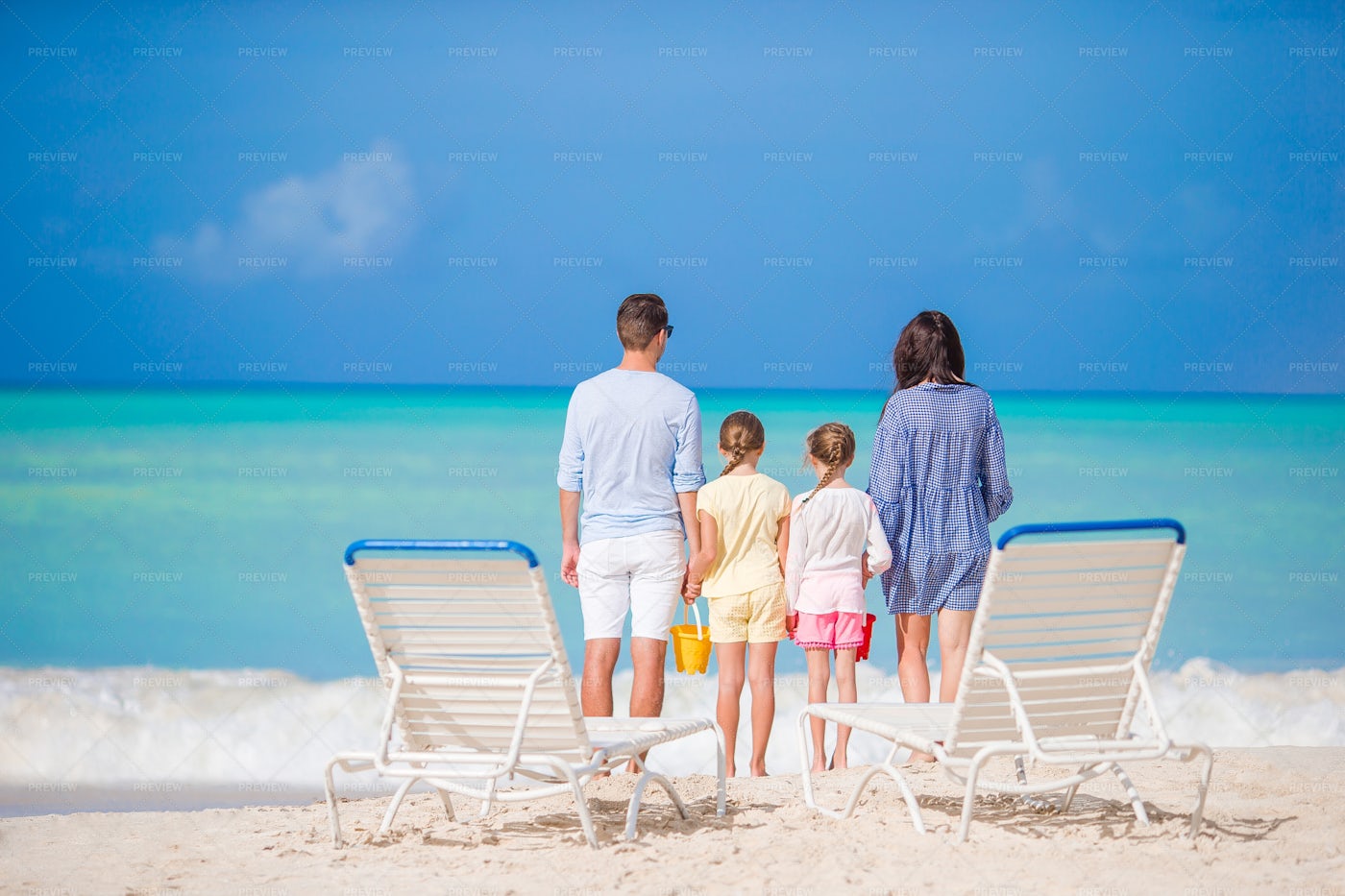 Family Standing At The Shore: Stock Photos