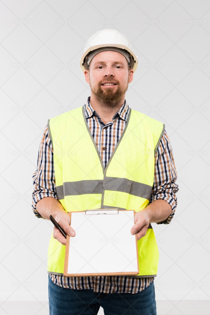 Cheerful Young Foreman Showing...: Stock Photos