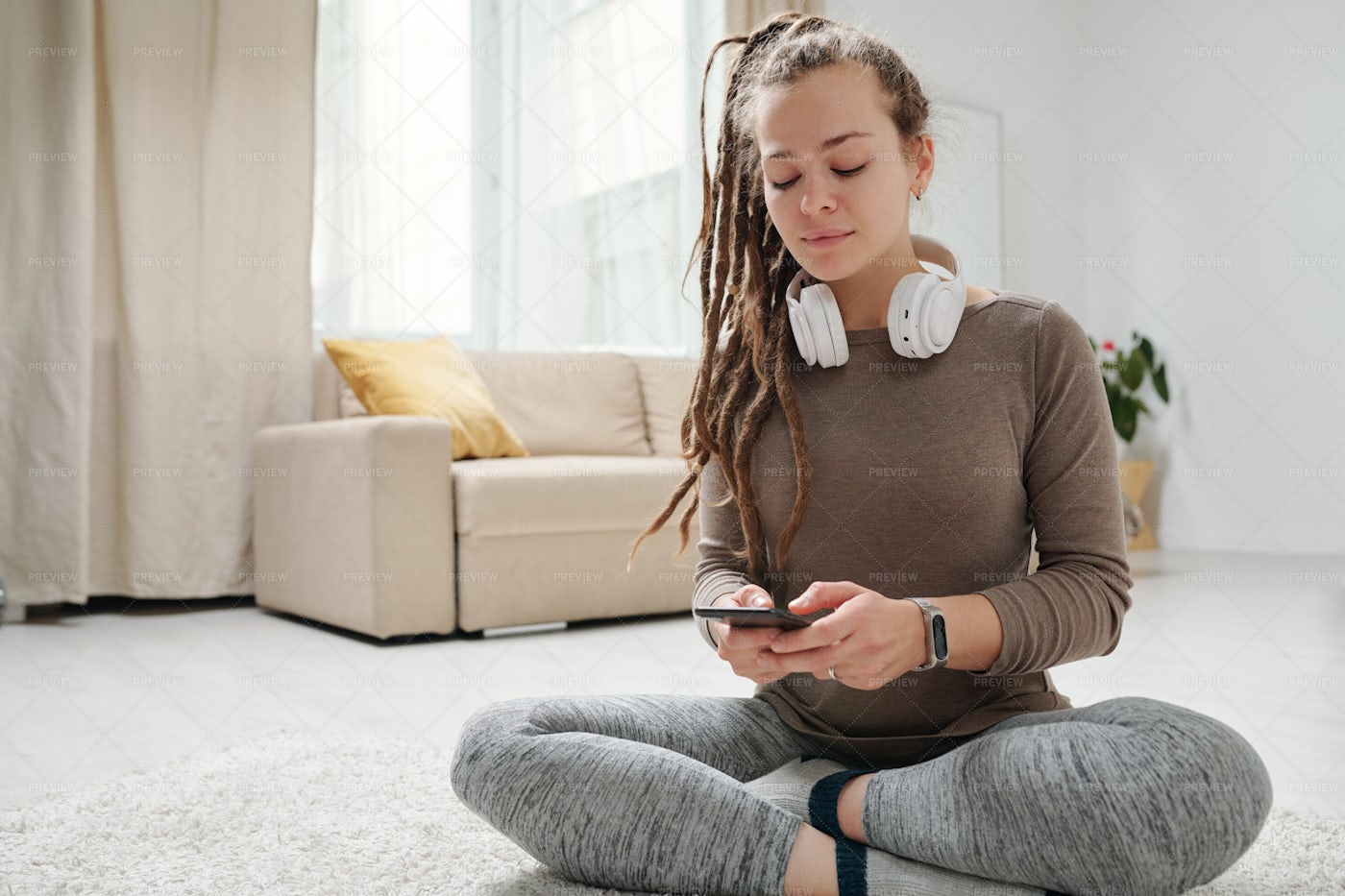 Girl With Dreadlocks Scrolling In...: Stock Photos