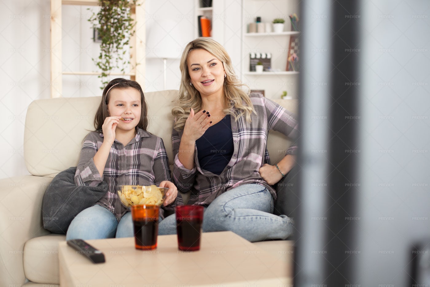Mother And Daughter Watching TV: Stock Photos