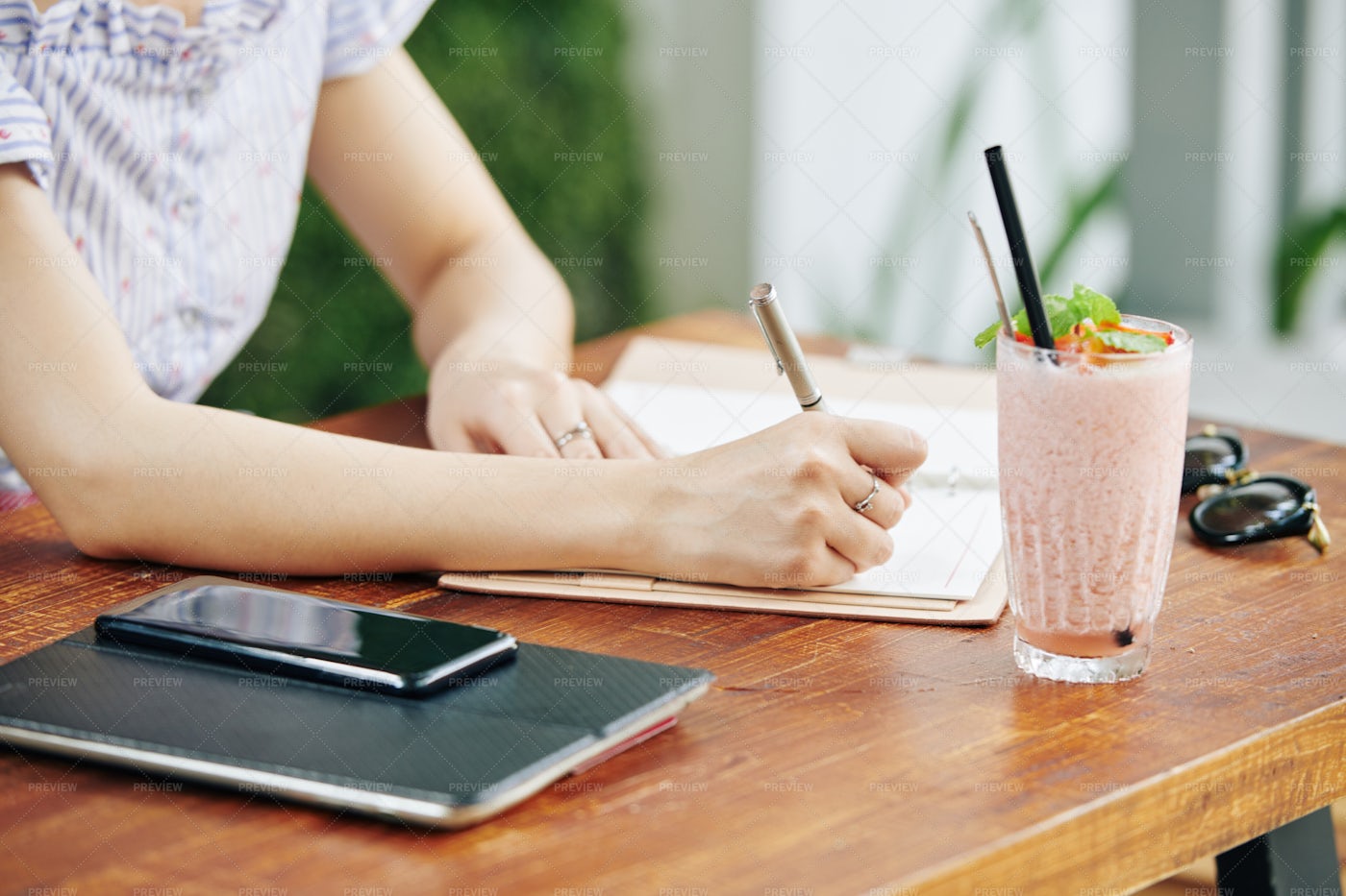 Female Student Writing In Notepad: Stock Photos