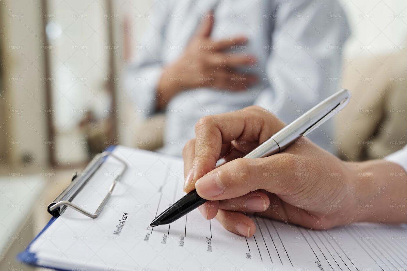 Doctor Filling The Medical Card: Stock Photos