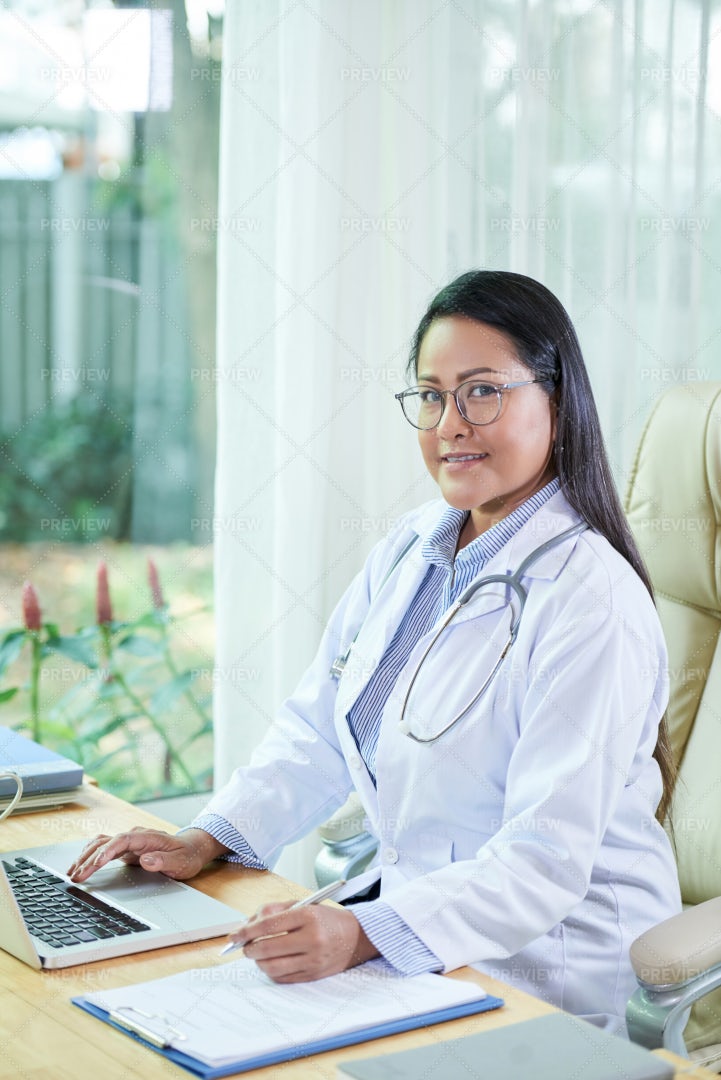 Doctor Filling Medical History: Stock Photos