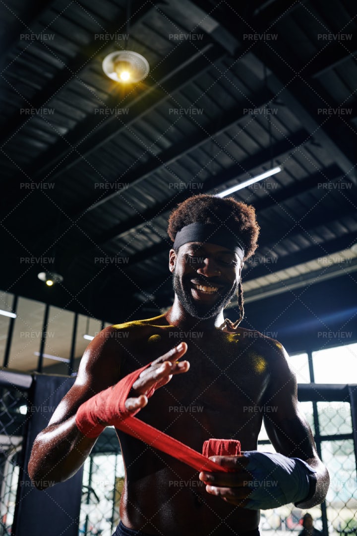 Boxer Wrapping Wrists With Bandage: Stock Photos