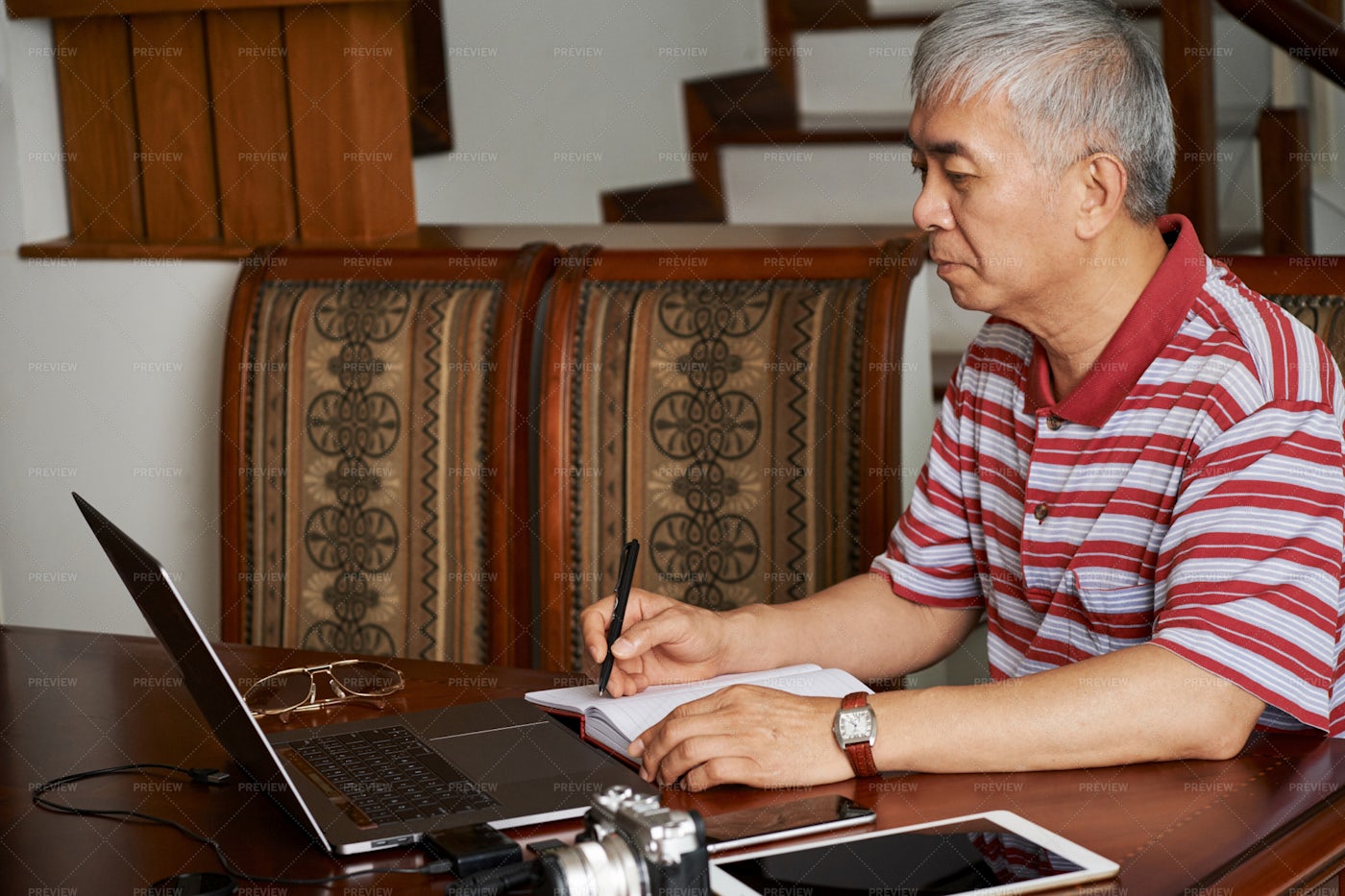 Photographer Planning Work In Notepad: Stock Photos
