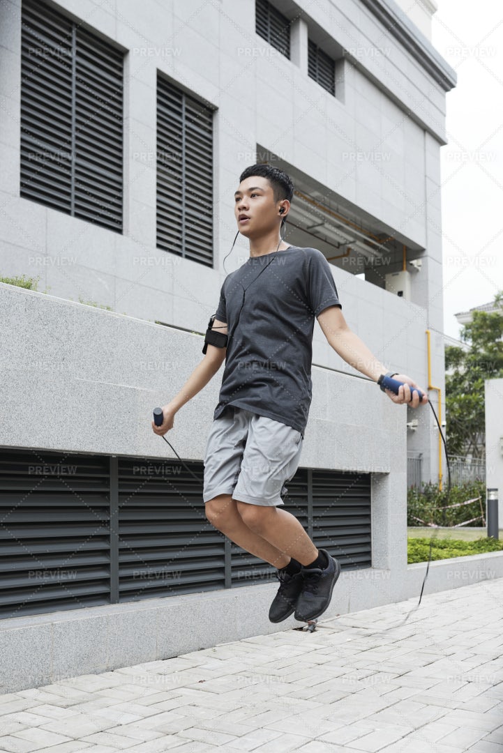 Jumping Asian Man: Stock Photos