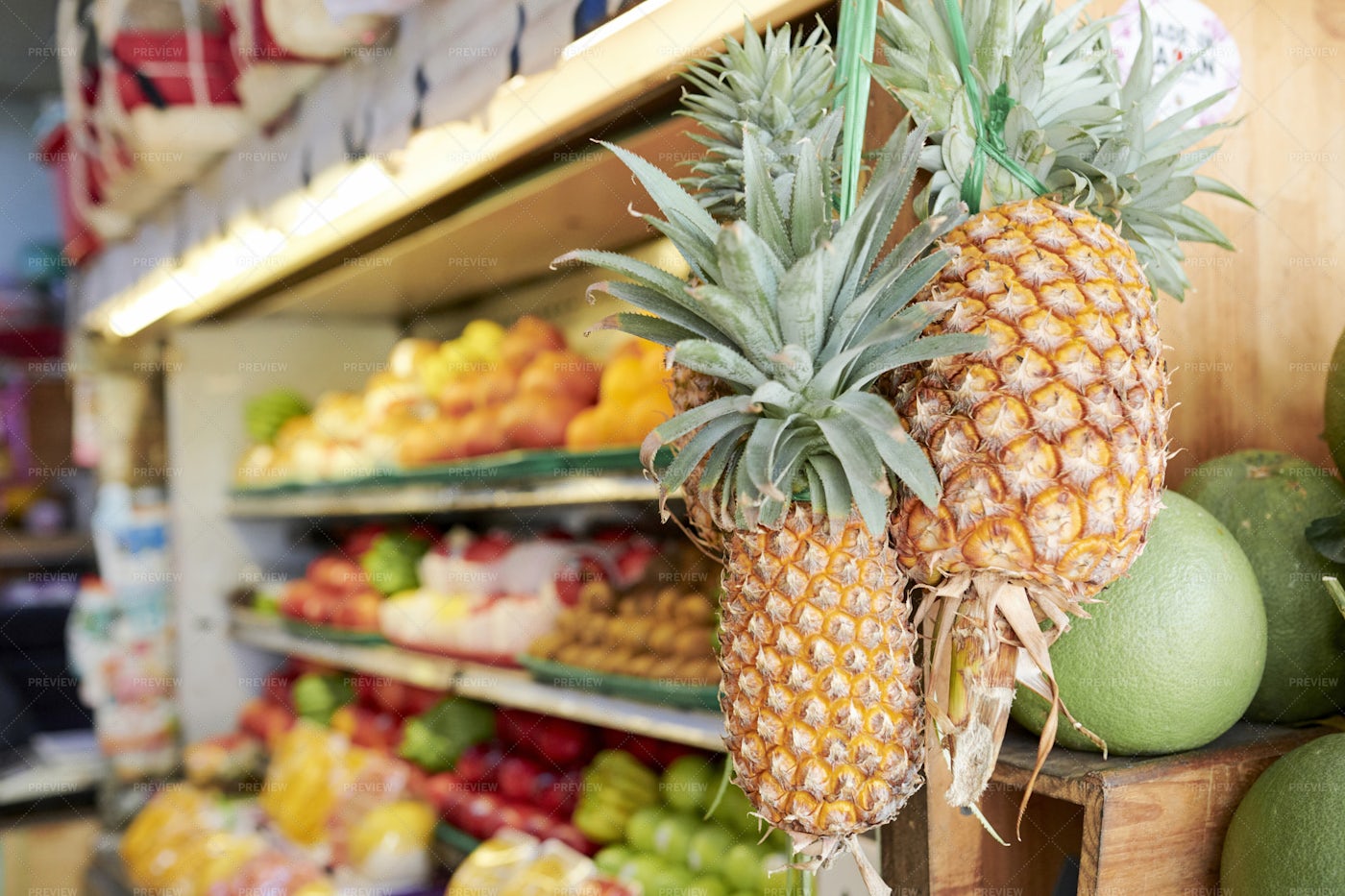 Pineapples Handing On Store Display: Stock Photos