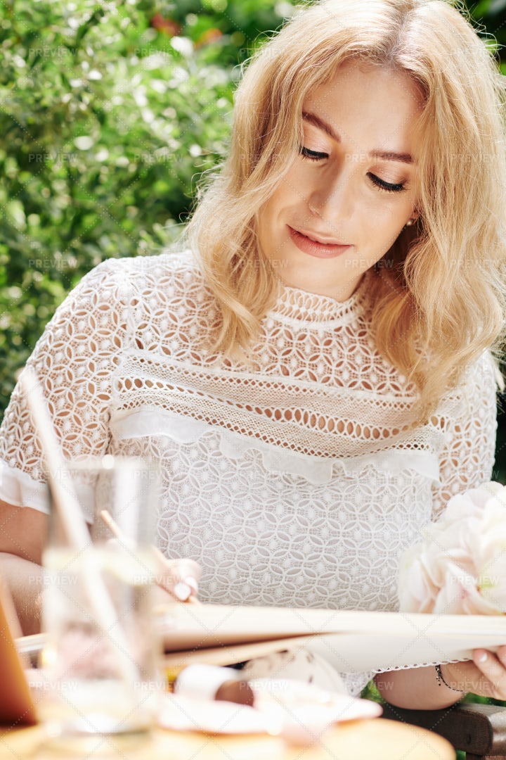 Businesswoman Taking Notes During Lunch: Stock Photos