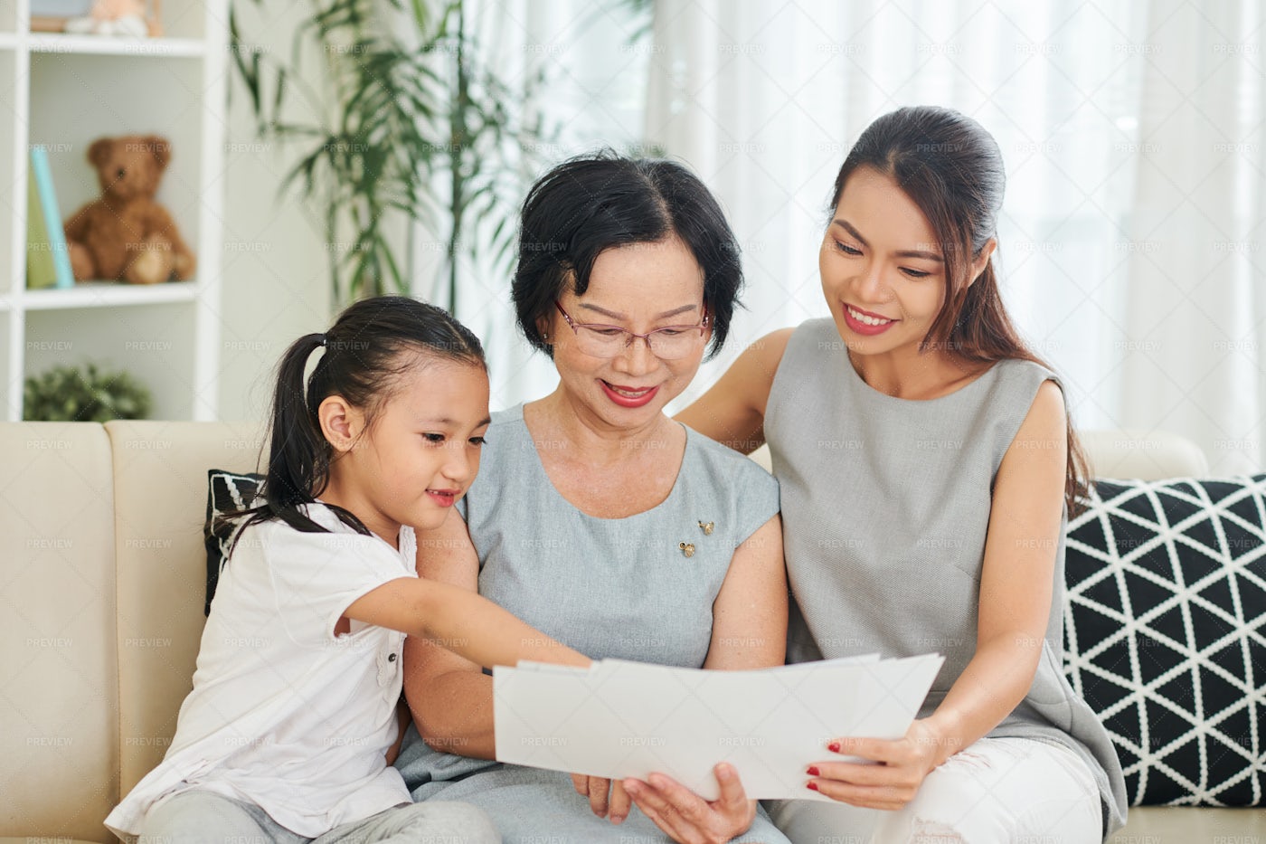 Family Reading A Letters At Home: Stock Photos