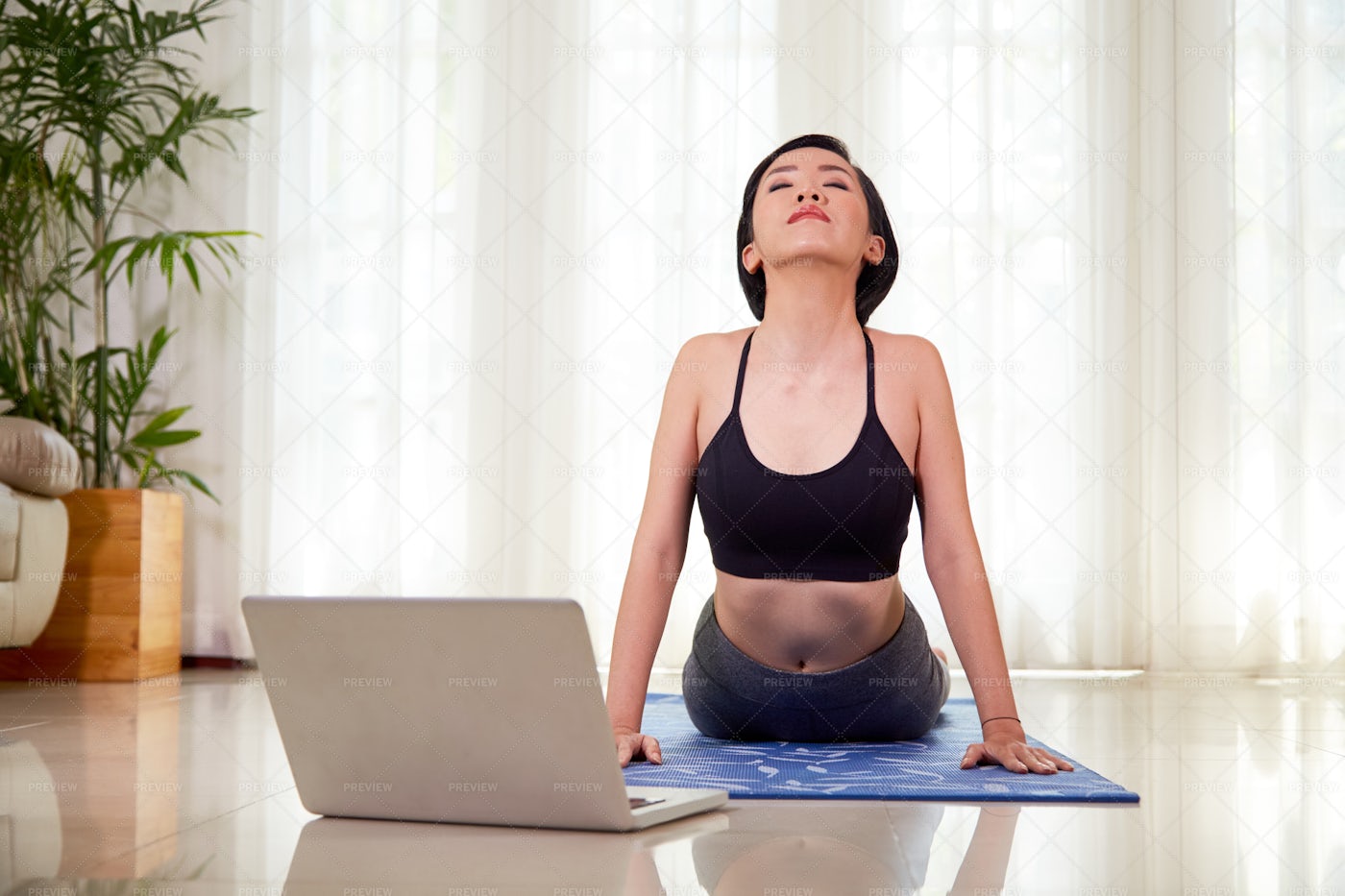 Woman Doing Stretching During Yoga: Stock Photos