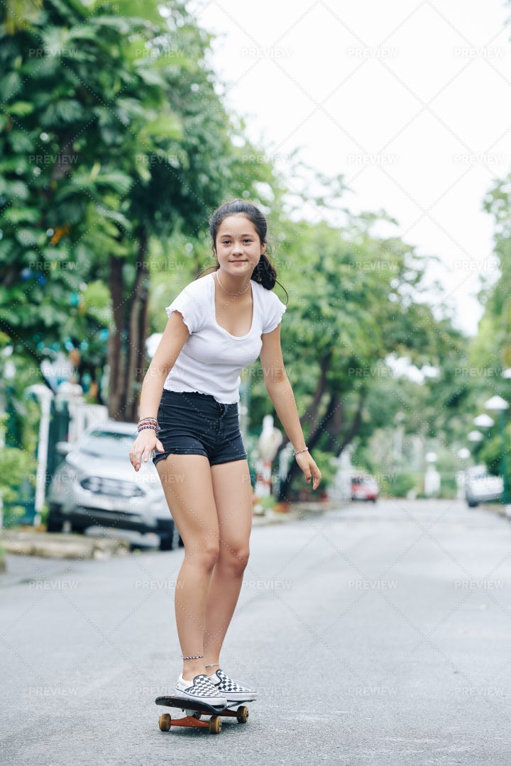 Girl Enjoying Riding On Skateboard: Stock Photos