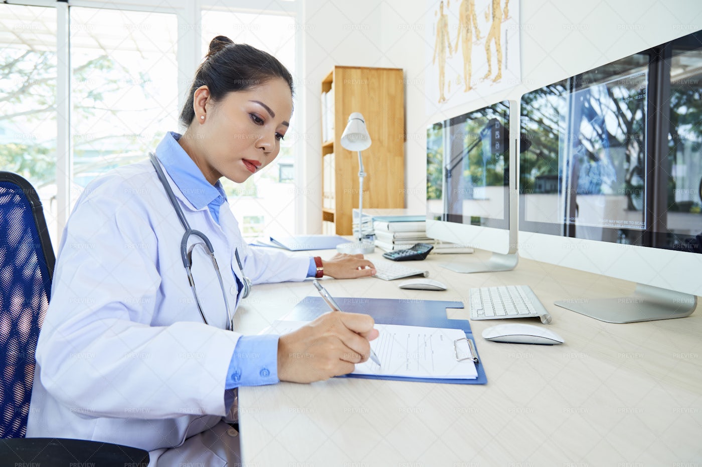 Busy Doctor Writing A Treatment: Stock Photos