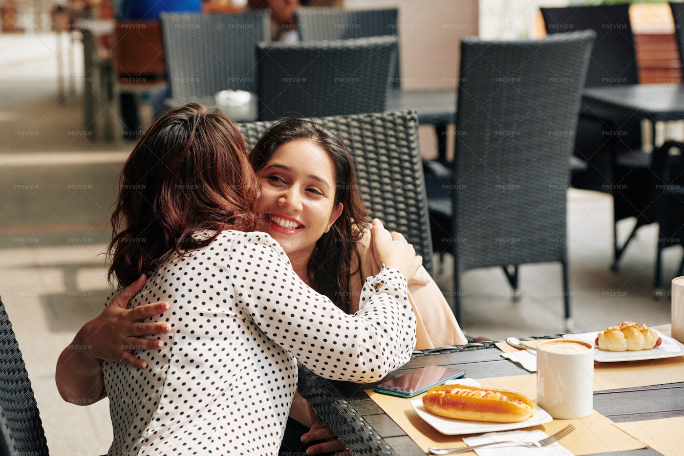 Firends Hugging At Cafe Table: Stock Photos
