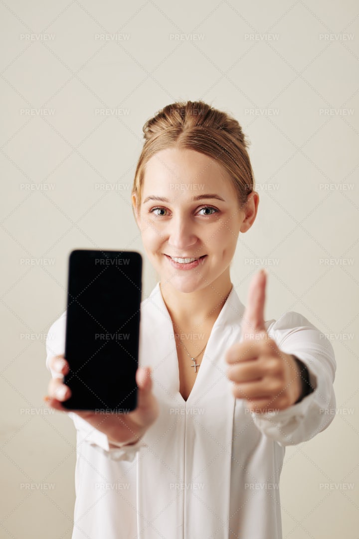 Happy Woman Showing Smartphone: Stock Photos