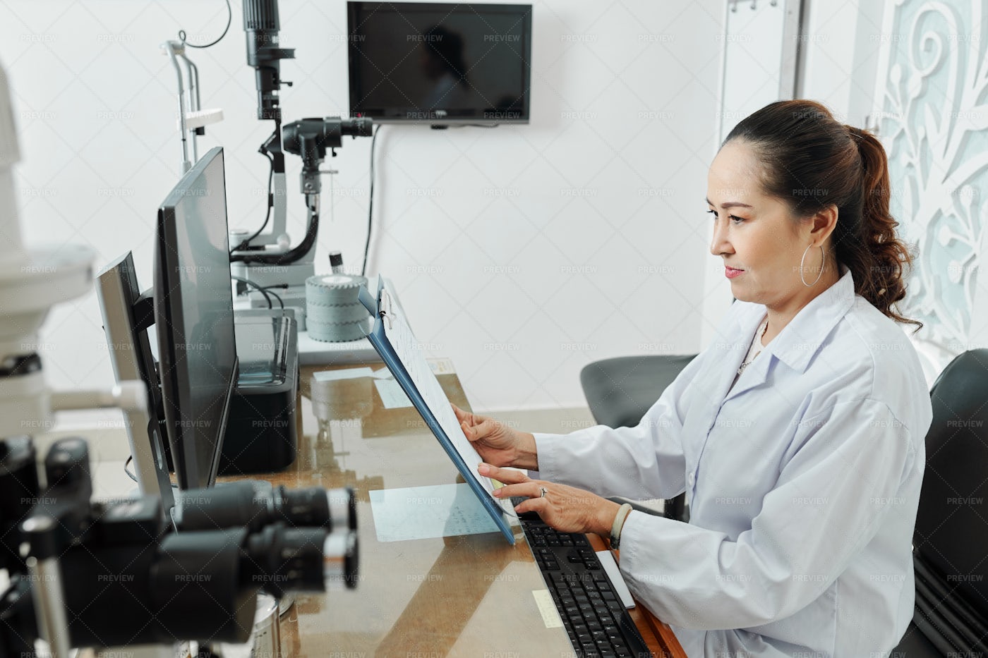 Doctor Examining Patient's Medical Card: Stock Photos