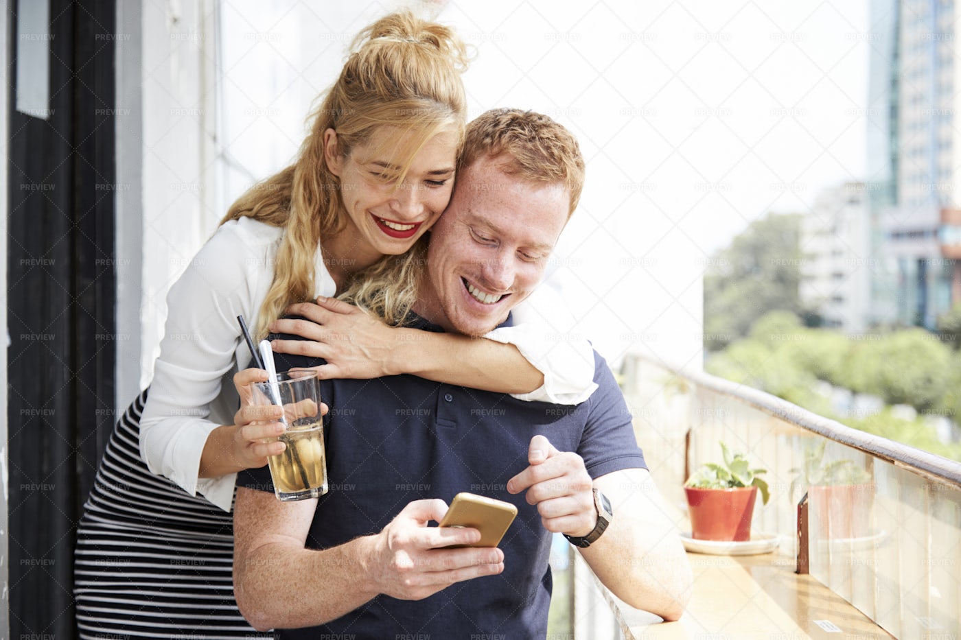 Positive Copule Checking Text Message: Stock Photos