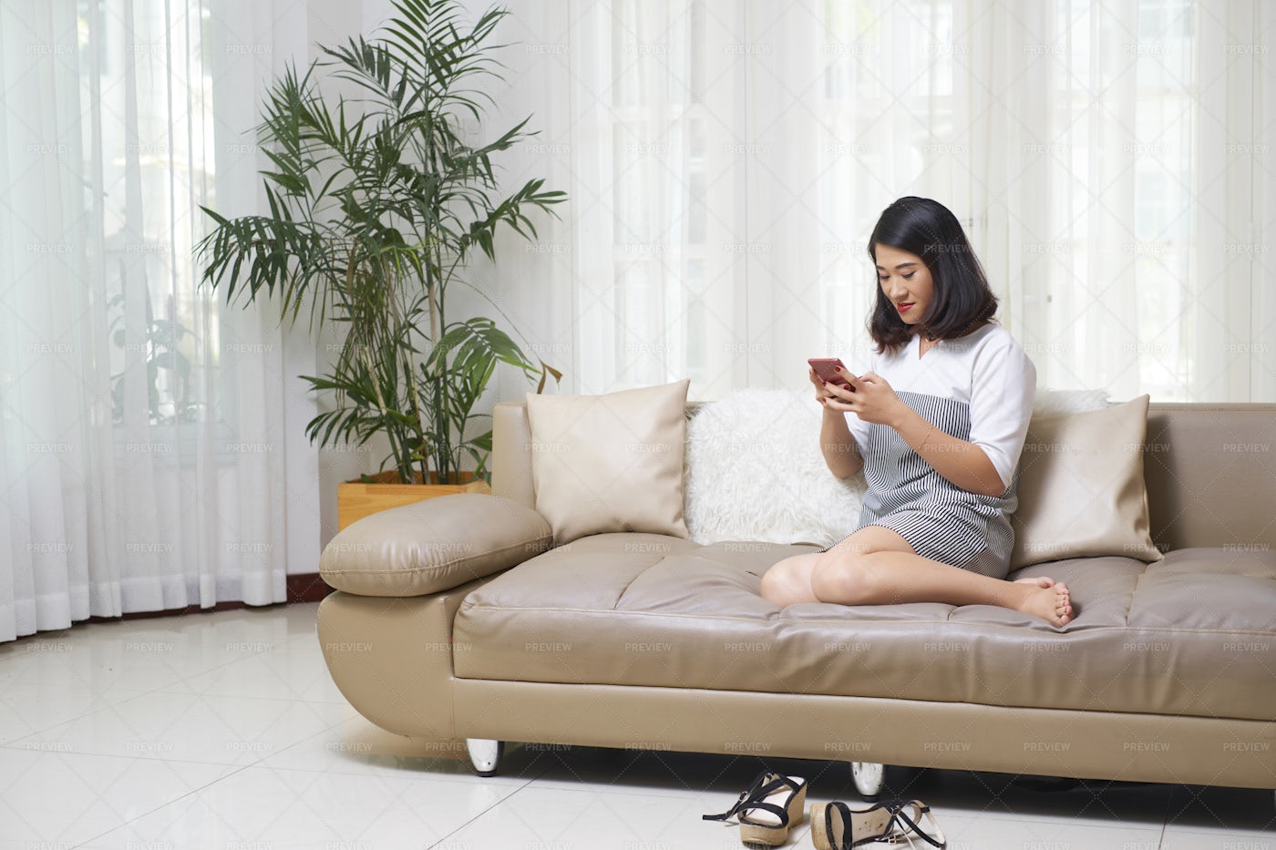 Woman Using Smartphone At Home: Stock Photos
