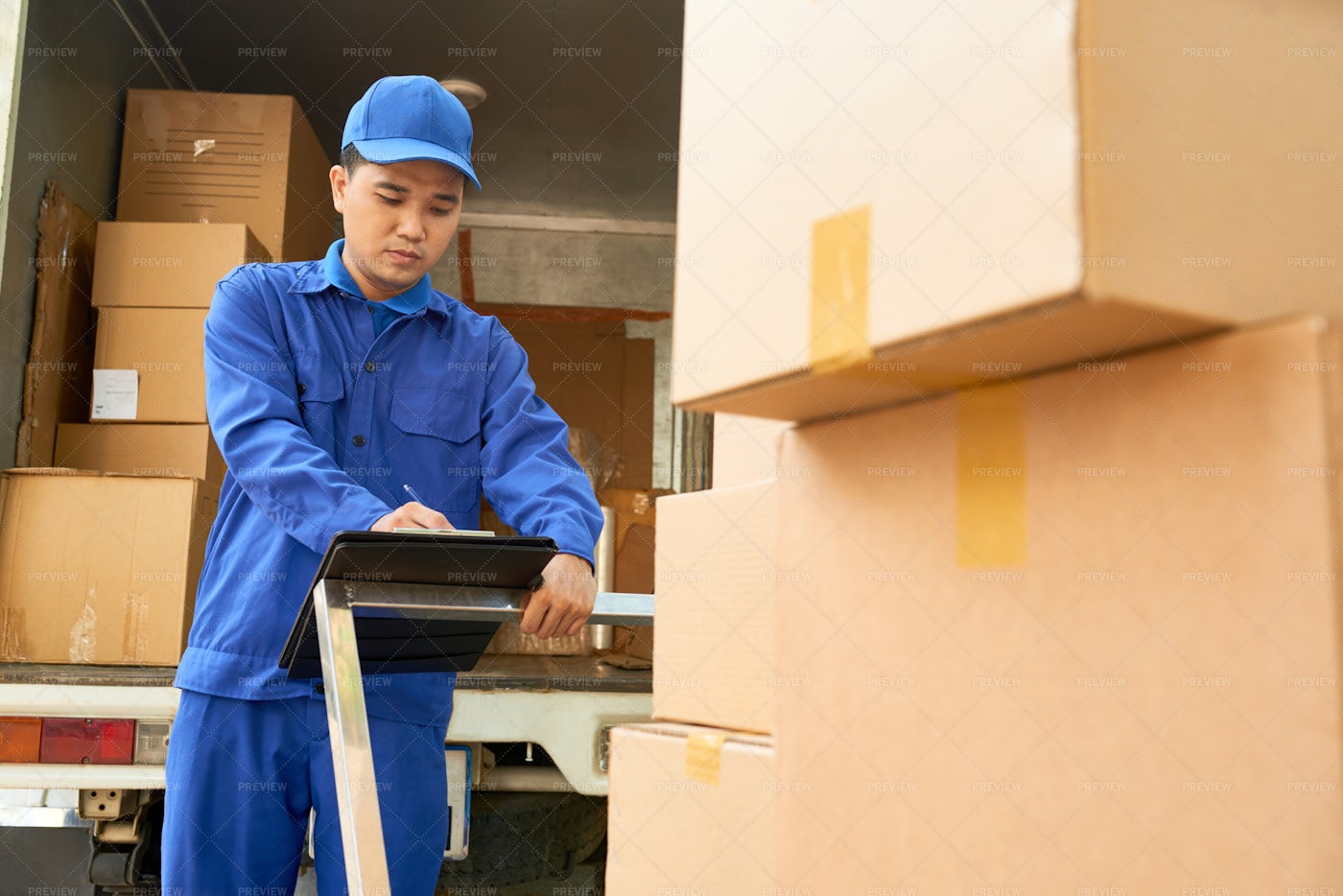 Delivery Man Checking Note: Stock Photos
