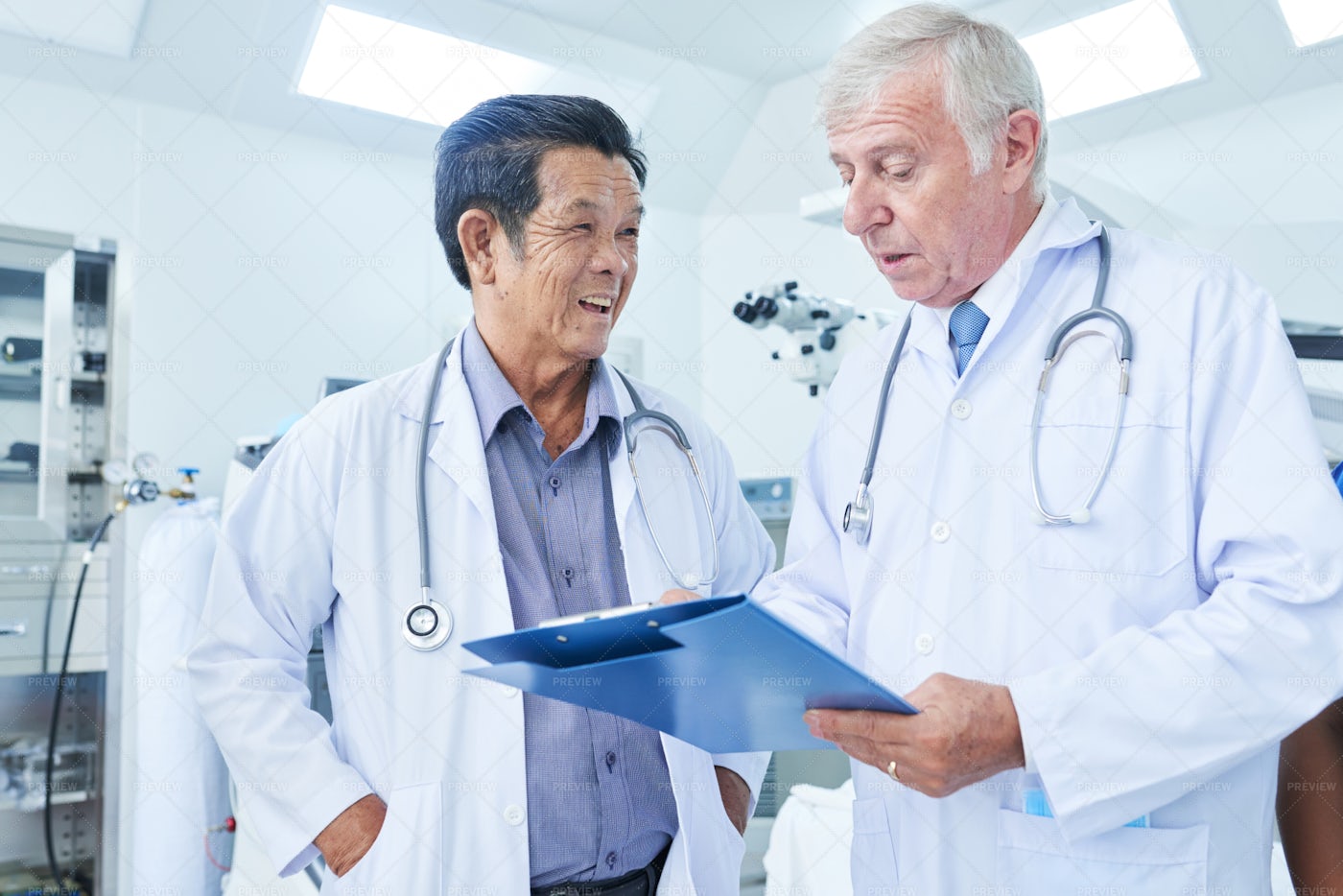 Physician Listening To Coworker: Stock Photos