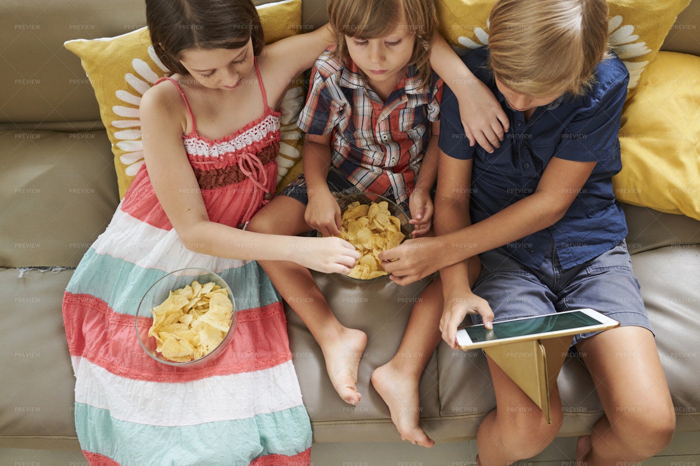 Friends Enjoying Chips And Cartoon: Stock Photos
