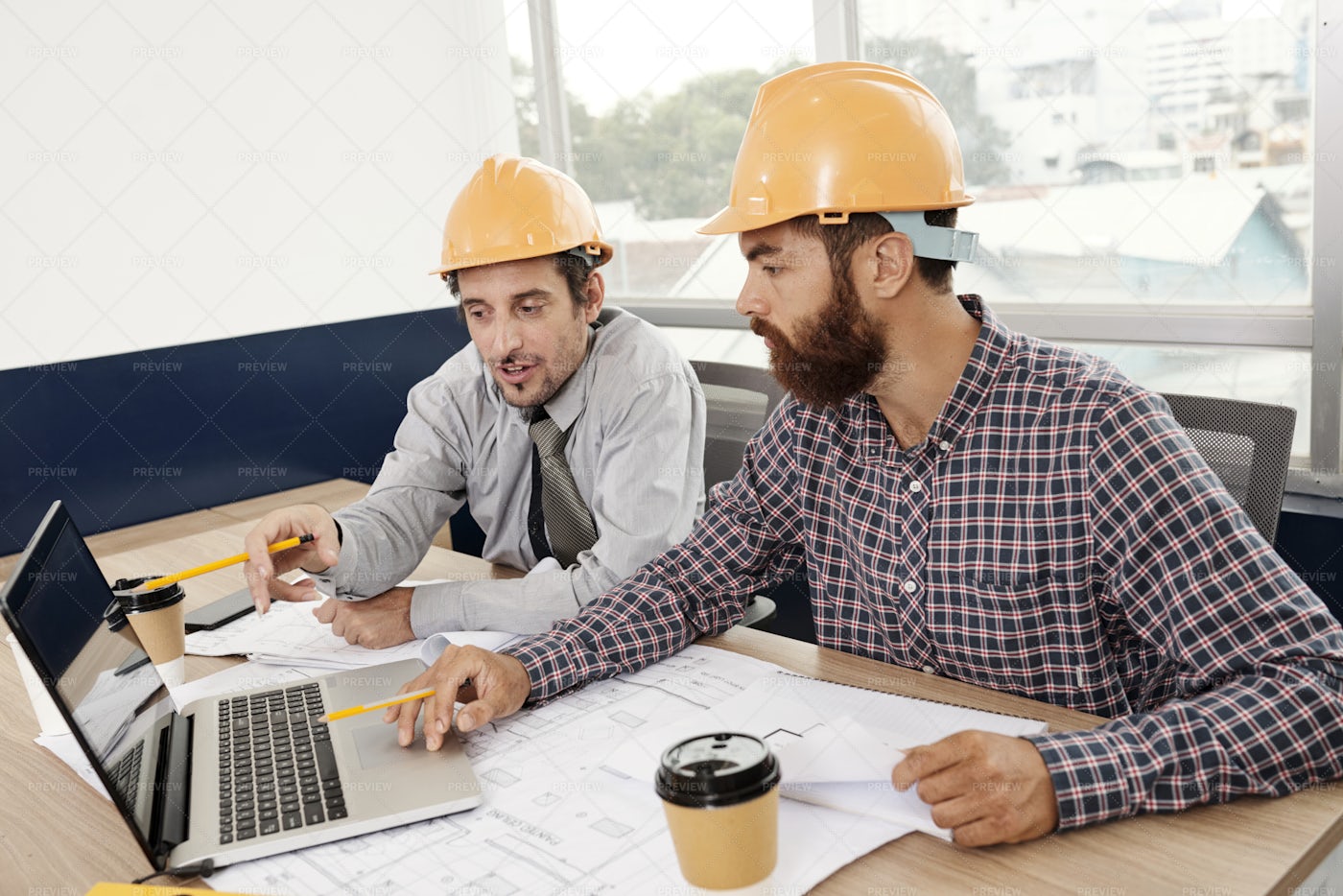 Engineers Discussing Project In Laptop: Stock Photos
