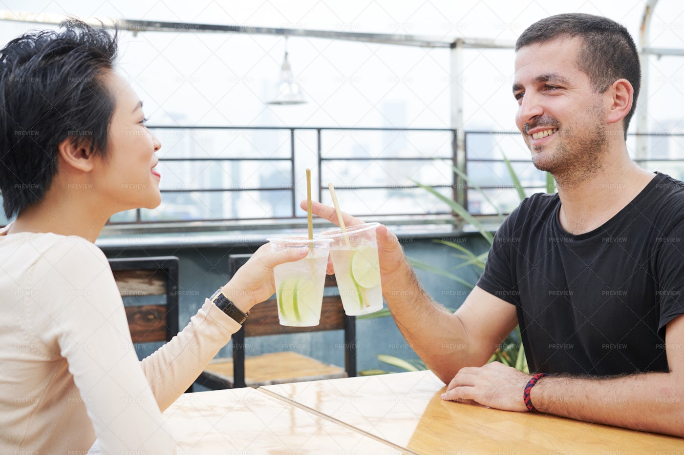 Couple Drinking Cold Cocktails In Cafe: Stock Photos
