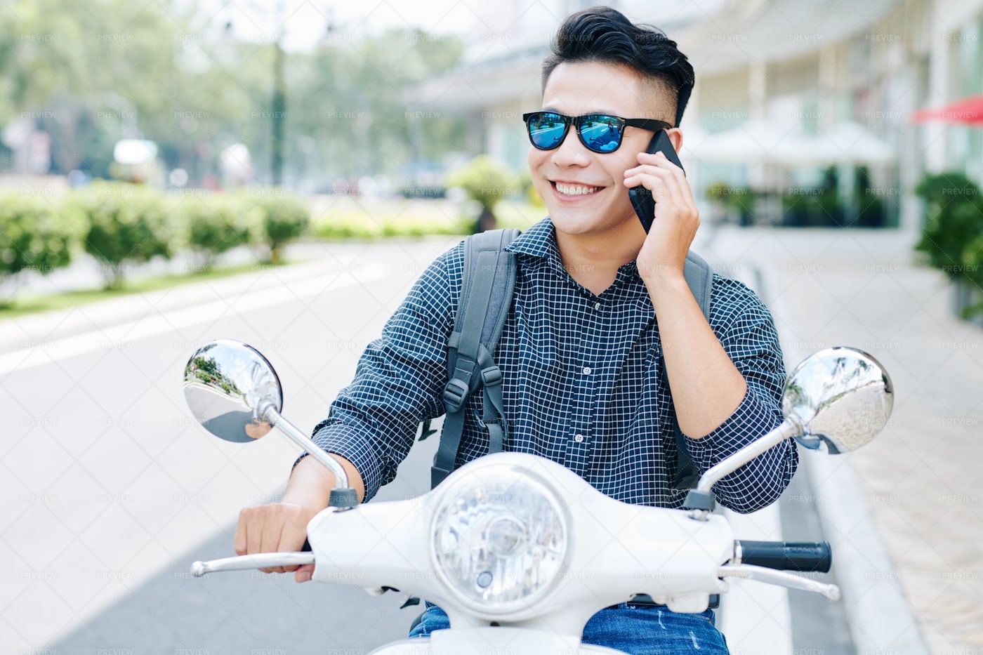 Smiling Man Riding On Scooter: Stock Photos