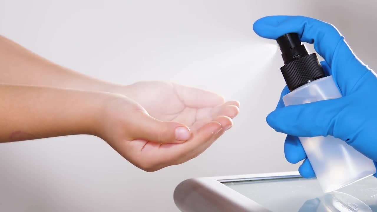 sanitizing-child-s-hands-with-spray-stock-video-motion-array