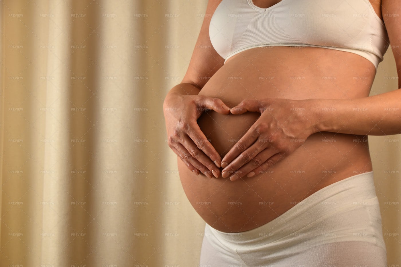Pregnant Woman Touching Her Belly: Stock Photos