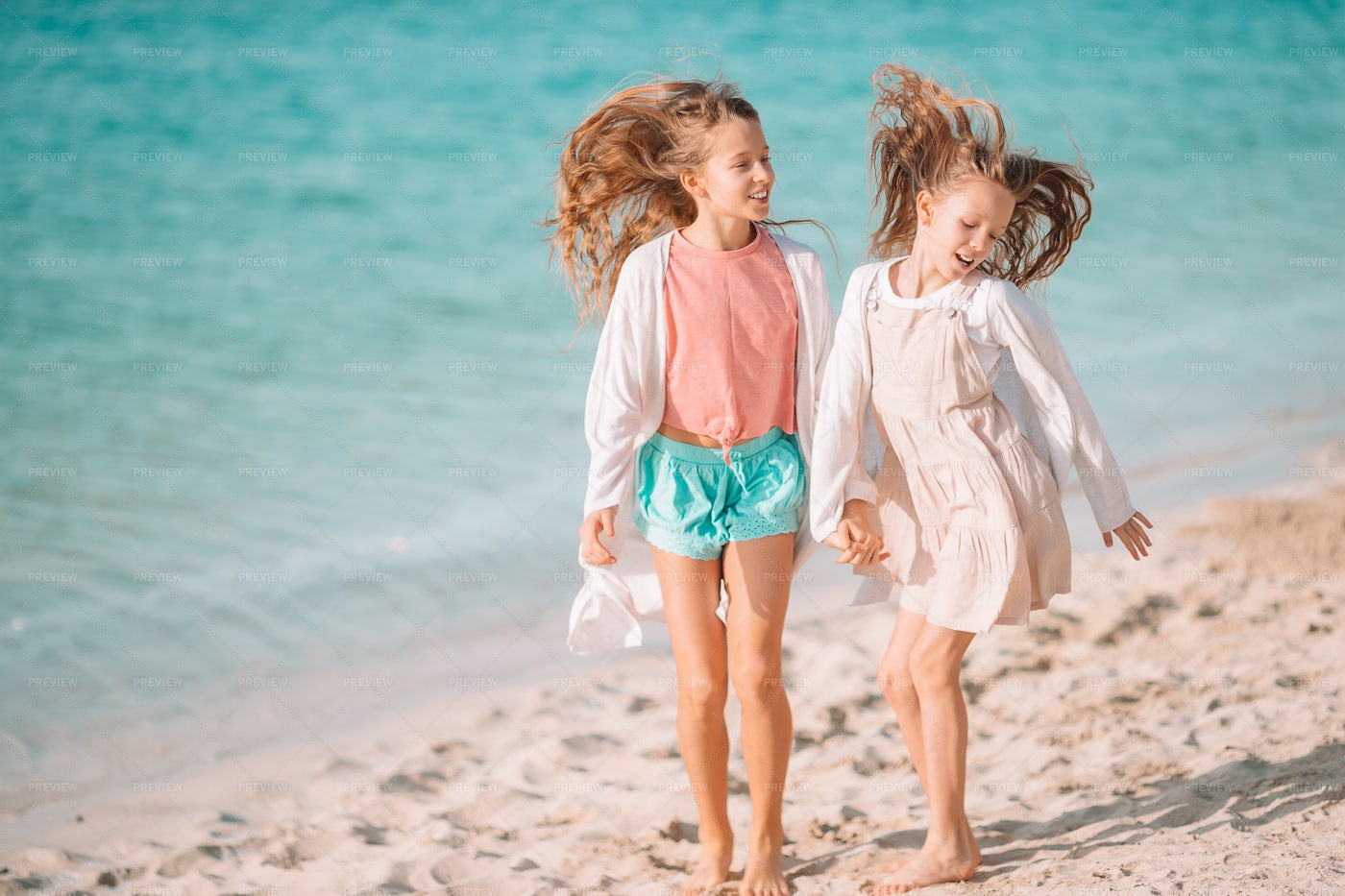 Sisters Enjoying The Beach: Stock Photos