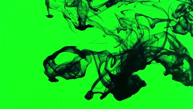 Black Ink Spread on Green Background: Stock Video