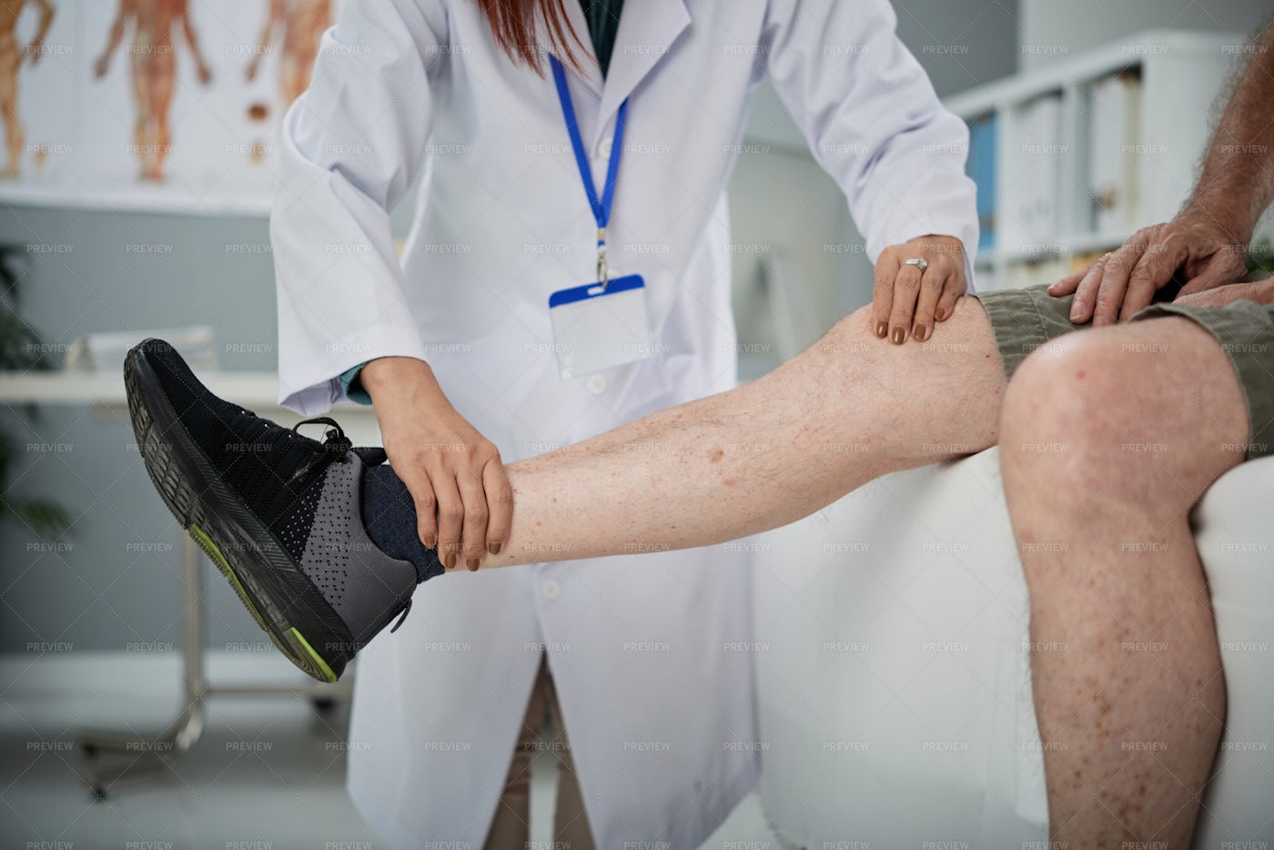 Physiotherapist Palpating Leg: Stock Photos