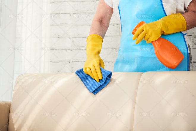 Housewife cleaning table Stock Photo by DragonImages