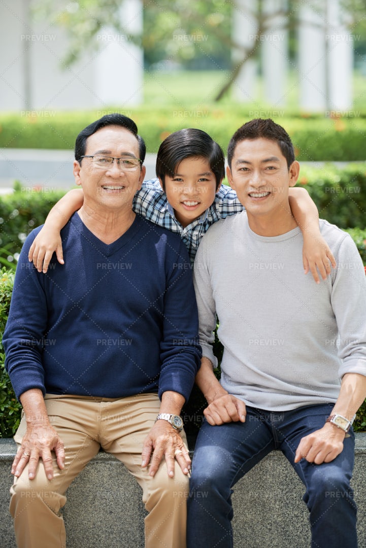 Asian Boy Hugging Father And...: Stock Photos