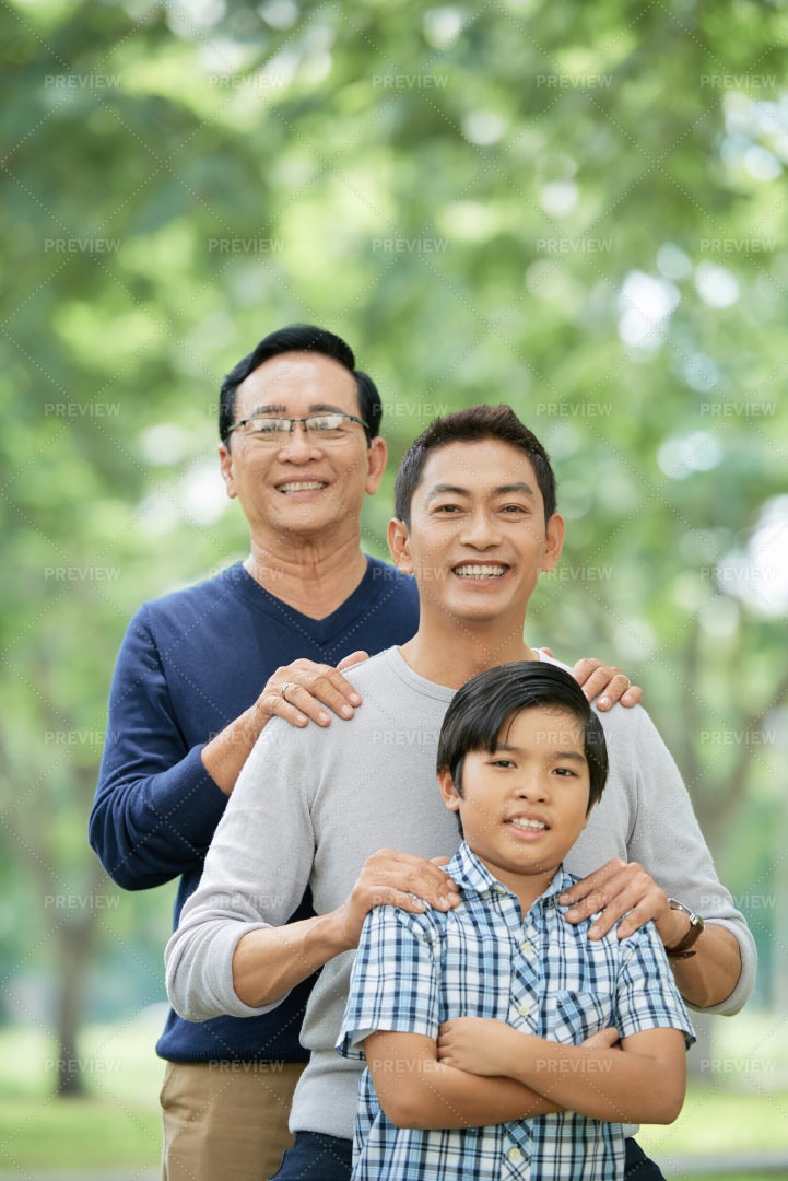 Confident Asian Boy With Father And...: Stock Photos