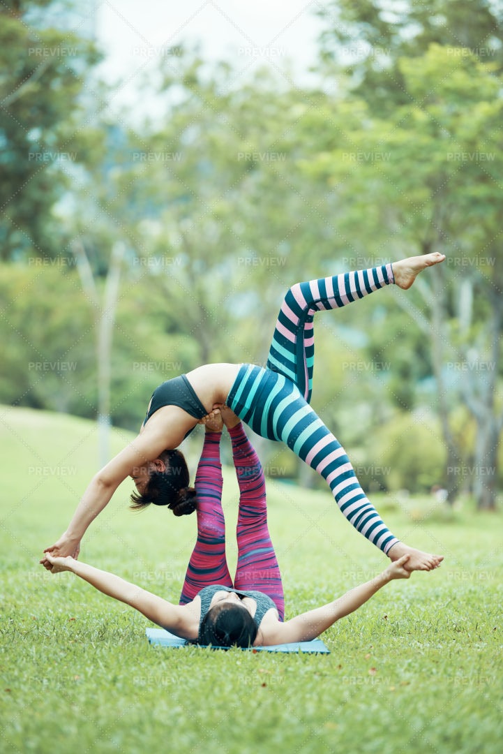 Fit Asian Acroyogis Practicing On...: Stock Photos