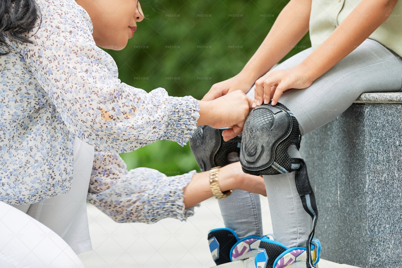 Mother Helping With Knee Pads: Stock Photos