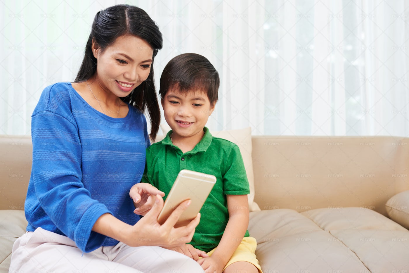 Mother And Son Using Smartphone: Stock Photos