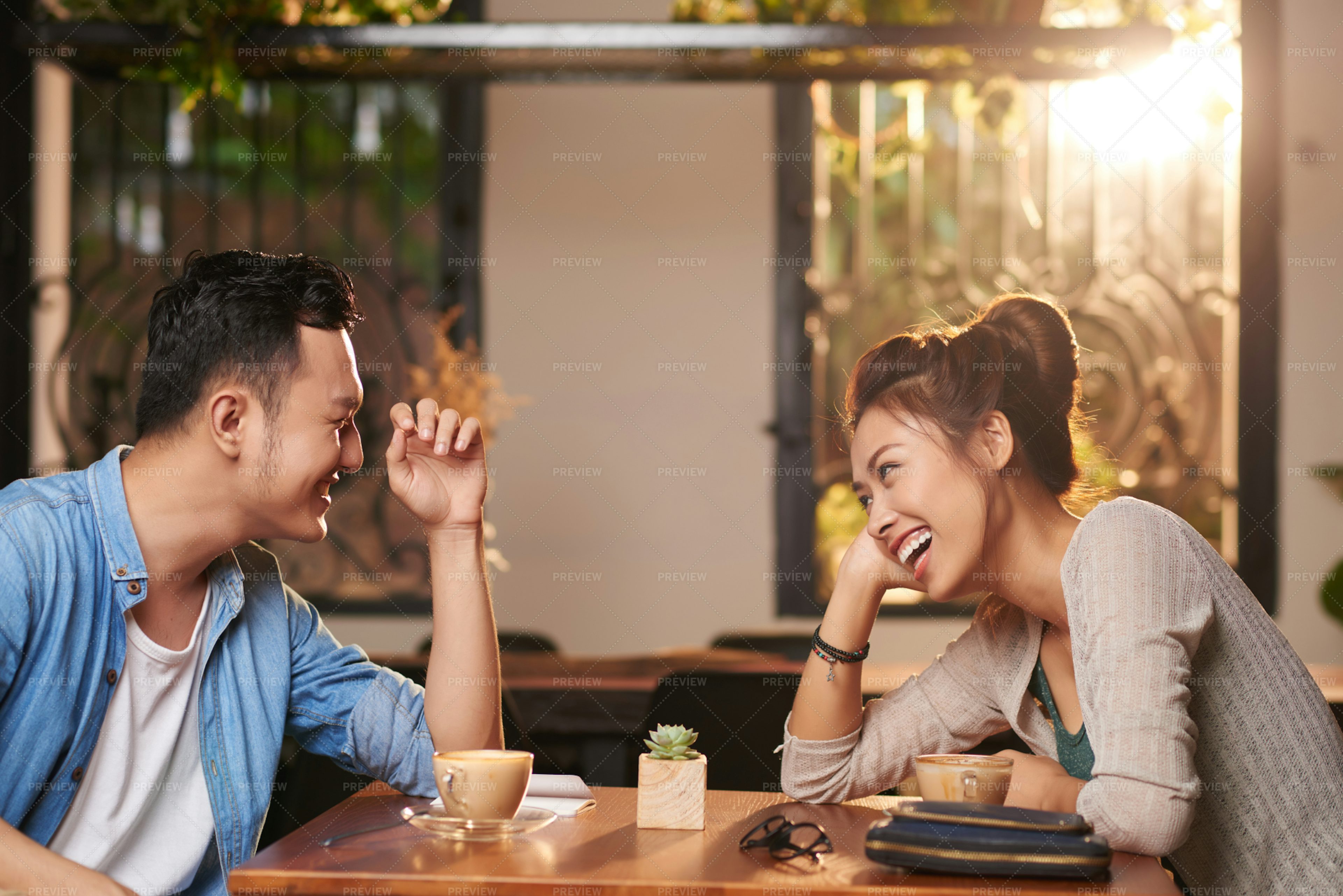 laughing-couple-on-date-in-cafe-stock-photos-motion-array