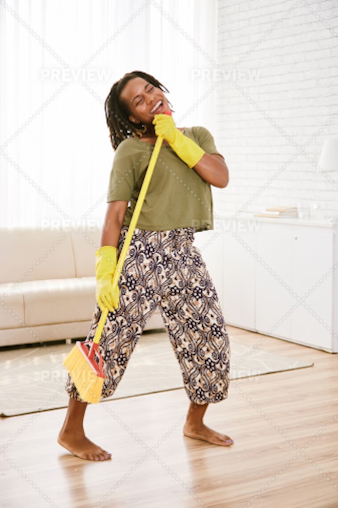 Housewife cleaning table Stock Photo by DragonImages