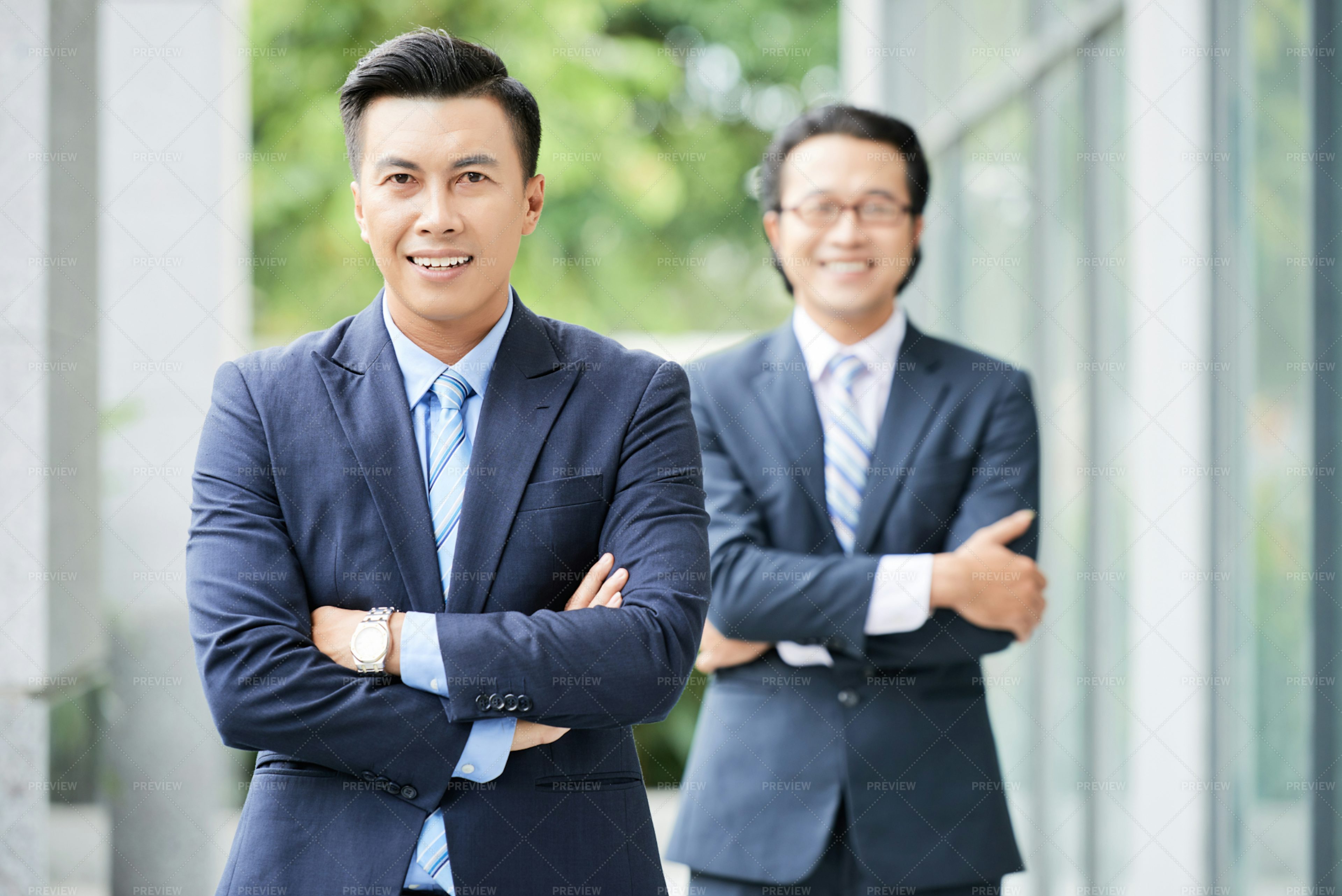 Cheerful Asian Businessmen Standing... - Stock Photos | Motion Array