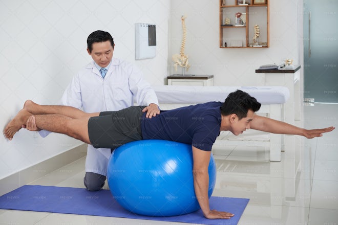 Exercising With Help Of Doctor - Stock Photos | Motion Array