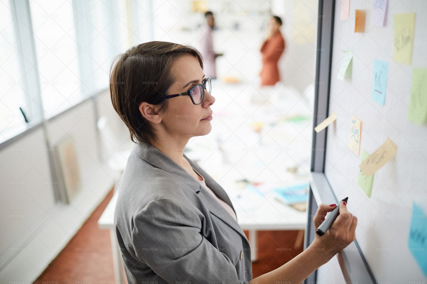 Businesswoman Writing On Whiteboard: Stock Photos