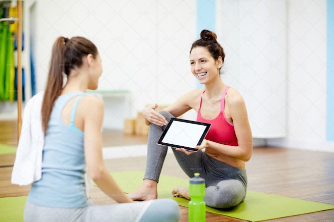 Women Using Tablet In Fitness Club - Stock Photos